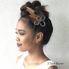 Hawaiian woman looking off into the distance with a beautiful braided crown of hair using Easy Updo Extensions in Dark Brown