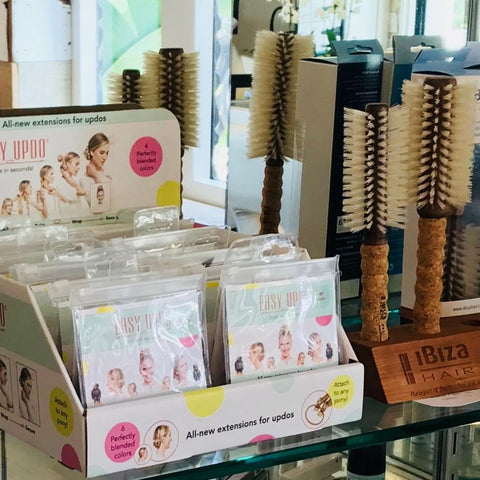 Retail case box display of Easy Updo extensions in a beauty salon with a display of round brushes