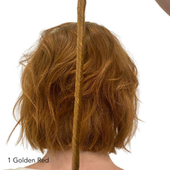 Golden Red Hair Easy Updo Volume Extensions held next to the back of the head of a red haired person
