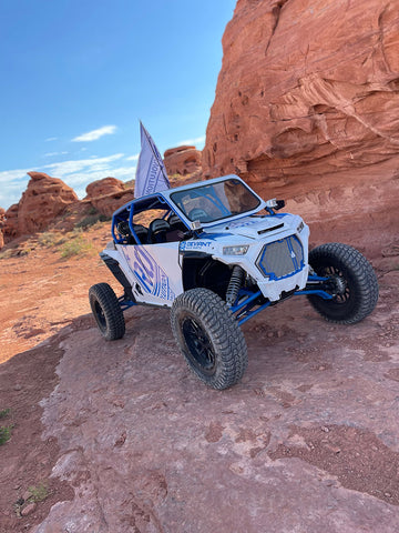 White RZR in the Red Rocks