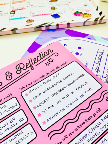 goal setting for the week ahead using pink manifesting desk planner by coconutacha