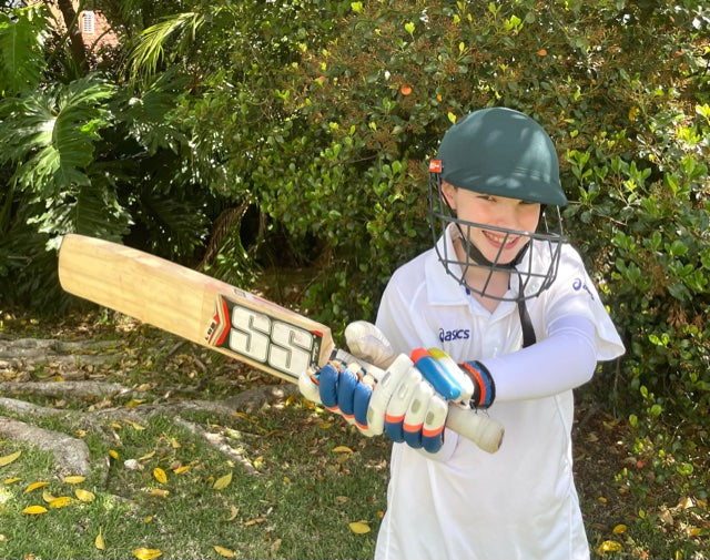 Boy cricketer in white arm sleeves by crazyarms