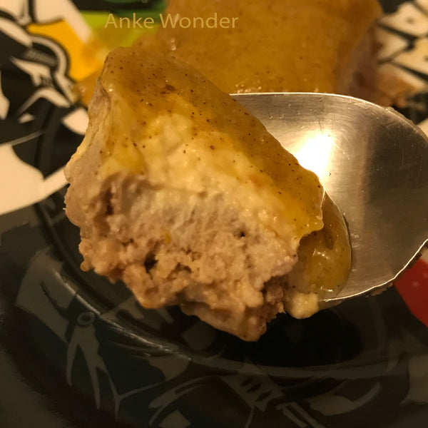 Raw vegan mango kiwi cheesecake on a spoon.