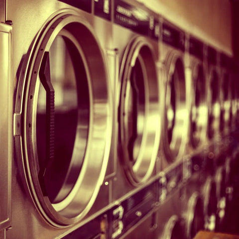 Several Washing Machines standing next to each other.