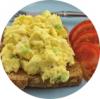 Image showing scrambled eggs on whole grain toast, with sliced tomato