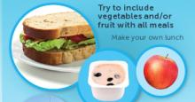 Image of a homemade lunch - wholegrain sandwich with lettuce and tomato, a pottle of yoghurt with blueberries and an apple