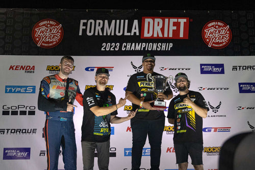 James Deane, Vaughn Gittin Jr, and Chelsea DeNofa accept the Formula Drift Manufacturer's Championship trophy