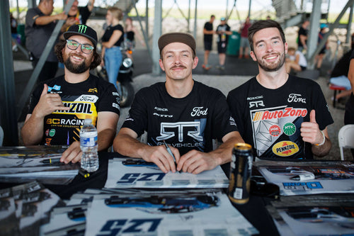 Chelsea DeNofa, Adam LZ, and James Deane sit at an autograph table