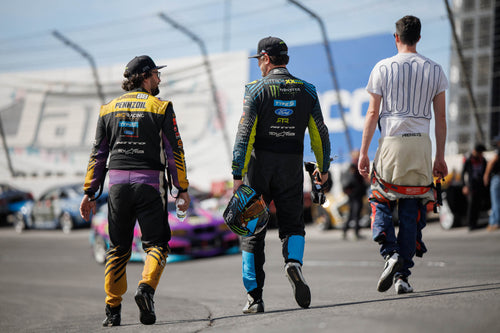 Chelsea DeNofa, Vaughn Gittin Jr, and James Deane walk down the track at Formula Drift Irwindale