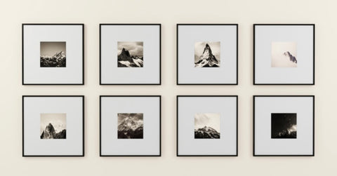 Gallery wall with black and white photos in black frames 