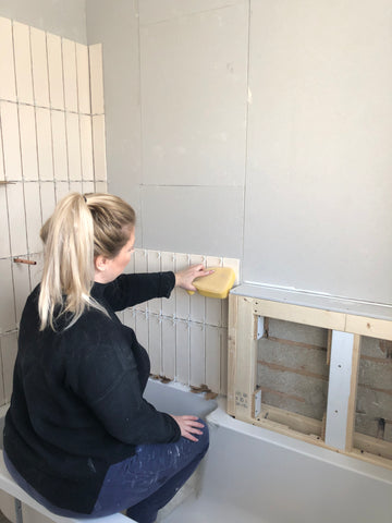 Girl tiling bathroom 