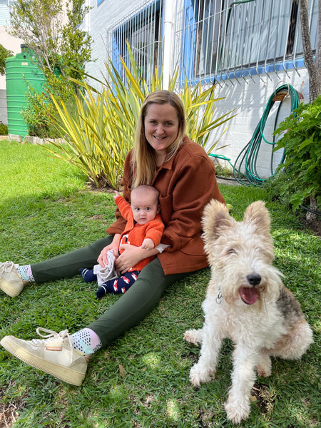 Photograph of Feat. Designer, Chelsey, with her son Billy and wire haired fox terrier, Teddie, in the garden