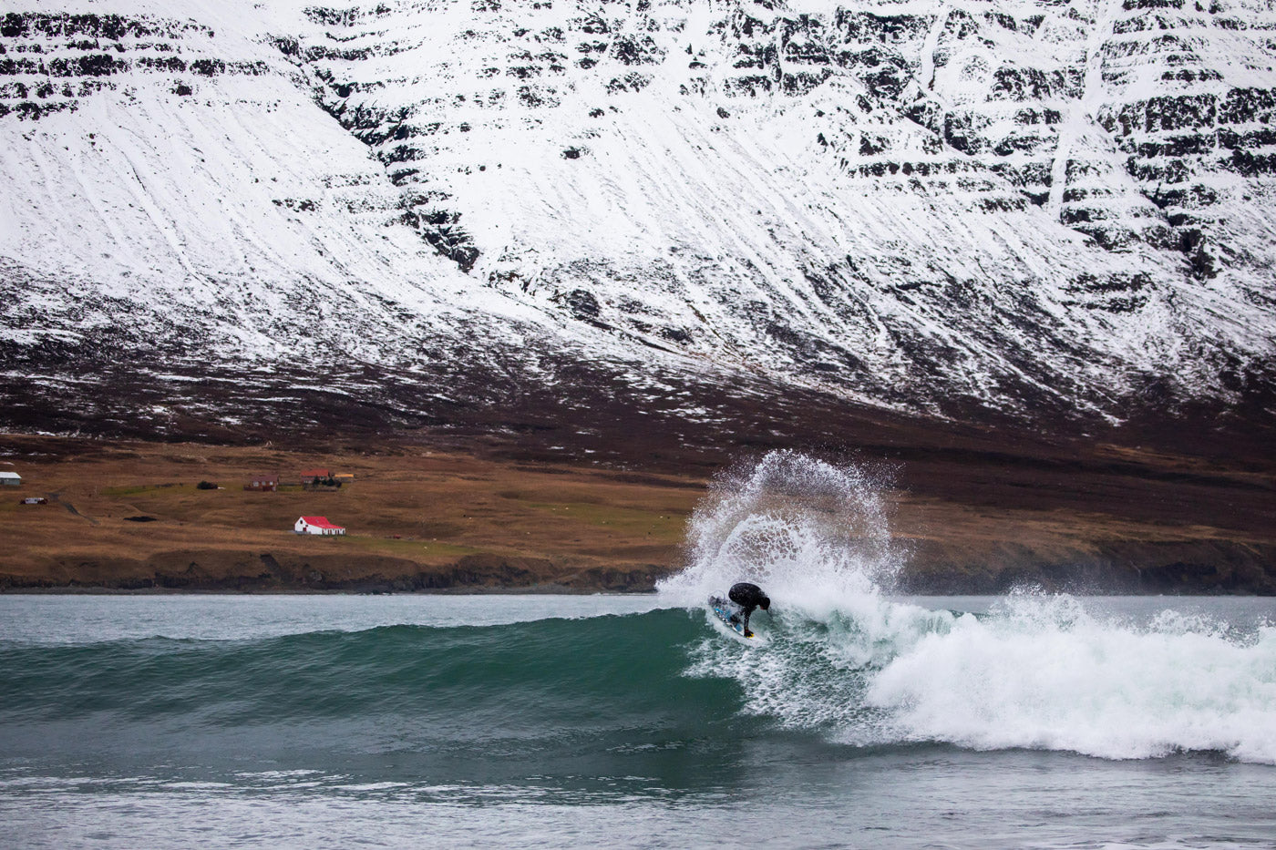 Jesse Mendes surfing Iceland with snow in the background