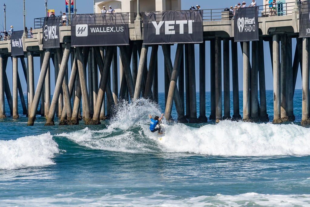 Nolan Rapoza surfing next to the Huntington Beach Pier