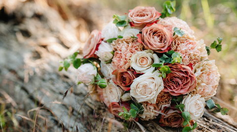 pink and white bridal bouquet on a wooden table