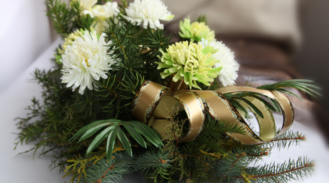 image of Christmas flower bouquet of yellow, green and white with metallic gold ribbon