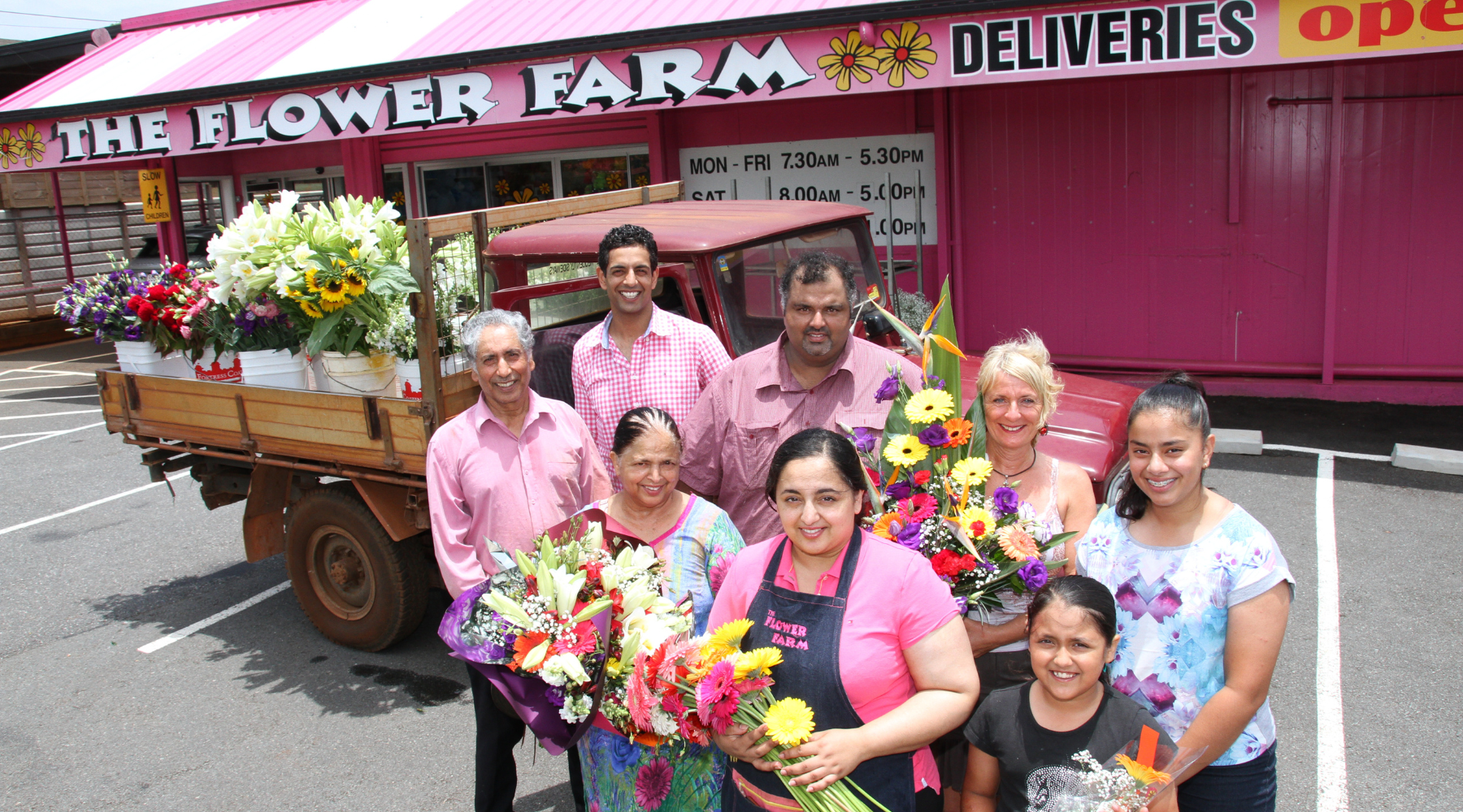 The Flower Farm team holding flowers in front of the Birkdale shop