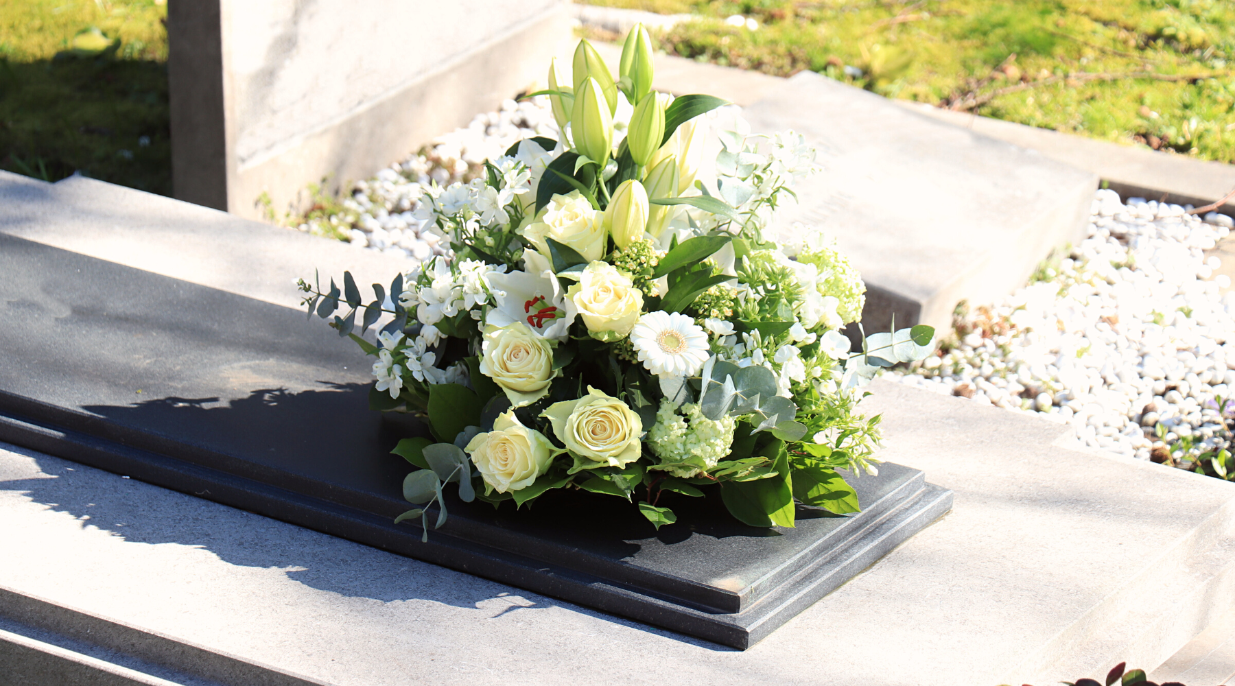 Image of white funeral flower arrangement on a casket