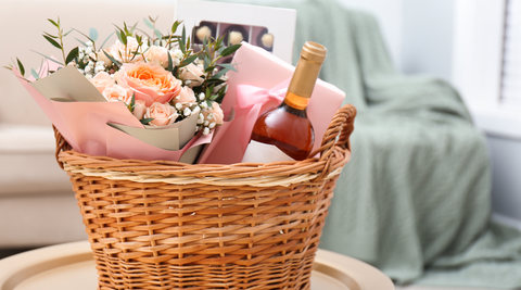 basket with pink roses flowers brisbane, a bottle of rose, chocolates and more