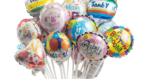 bunch of mini balloons on white sticks with multicoloured images, patterns and different phrases like Thank You and New Baby