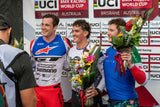 three BMX World Champions holding stunning The Flower Farm podium flower arrangements