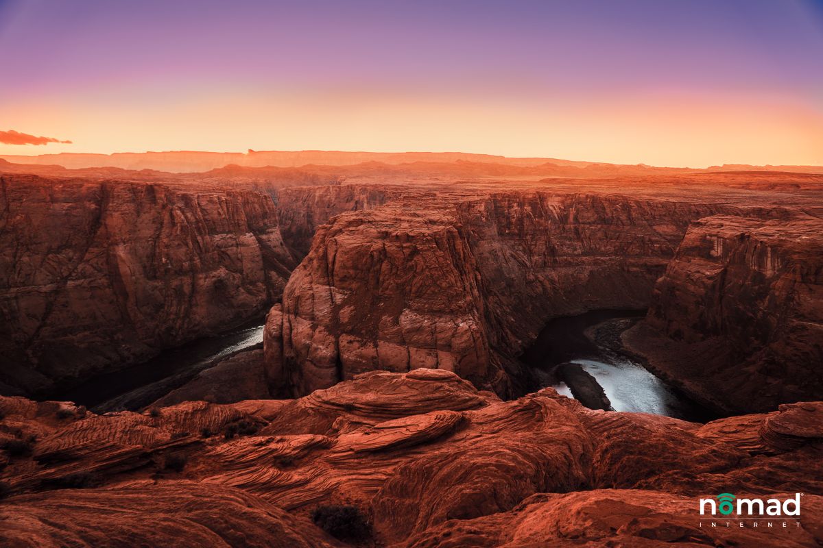 A photo of the sun setting over the Grand Canyon.