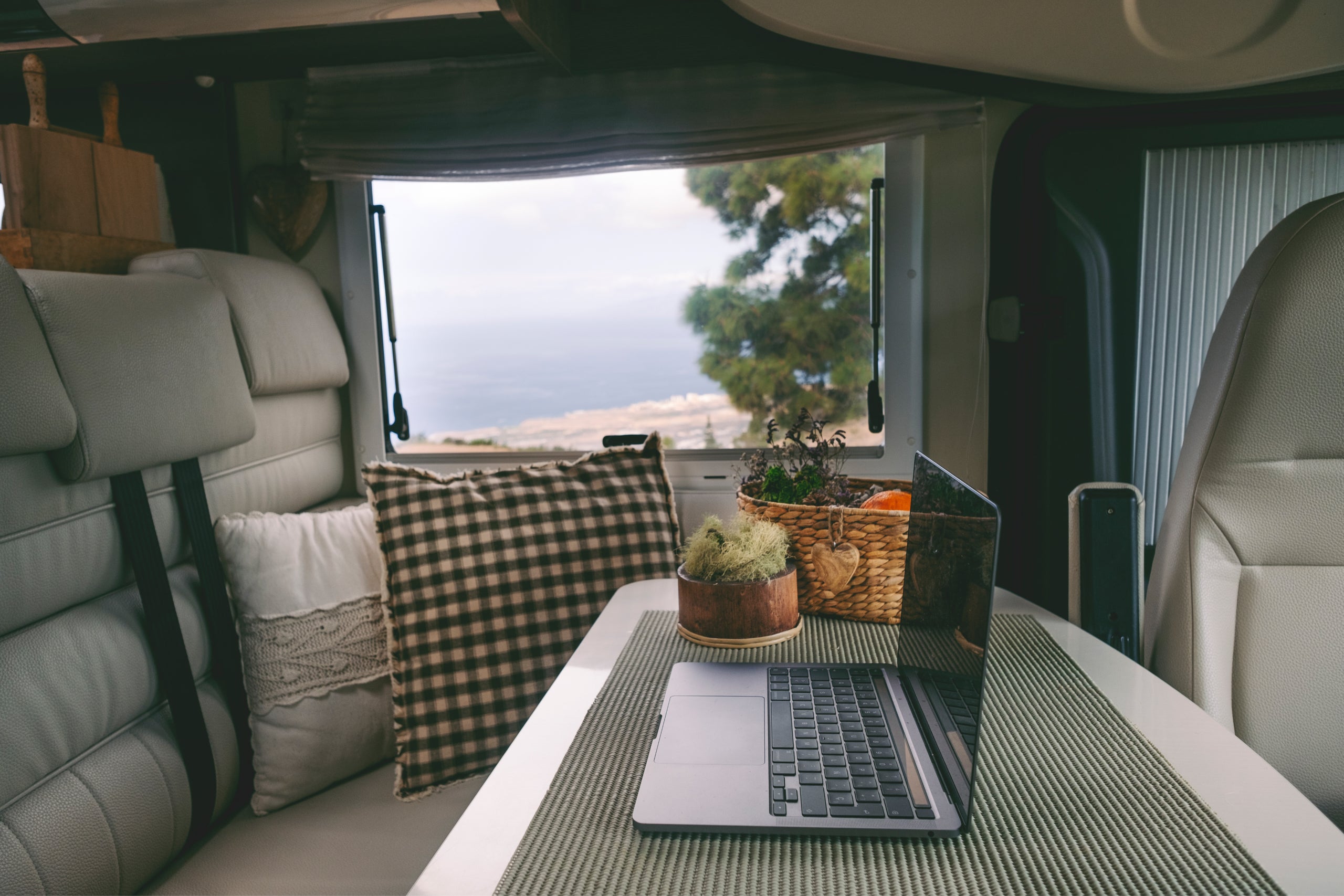 Travel lifestyle online digital nomad work place inside modern camper van