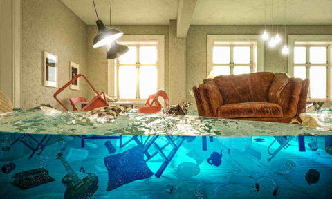 Furniture floating in a flooded living room. Bed Bug heaters are used to dry out flood damaged homes.