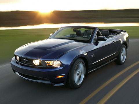 The sun sets in the distance behind the hills, still reflecting off the blue Mustang GT 500.