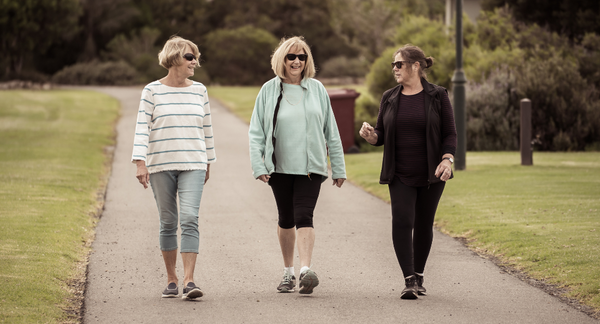 Three women walking in local park