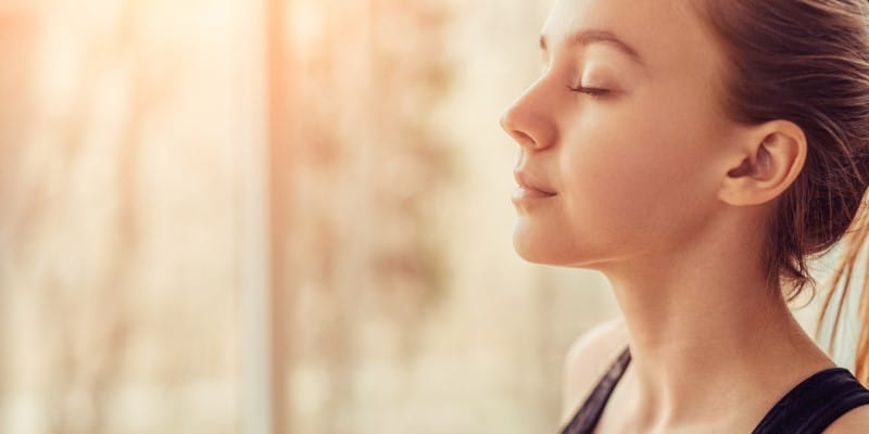 Woman eyes closed breathing deeply