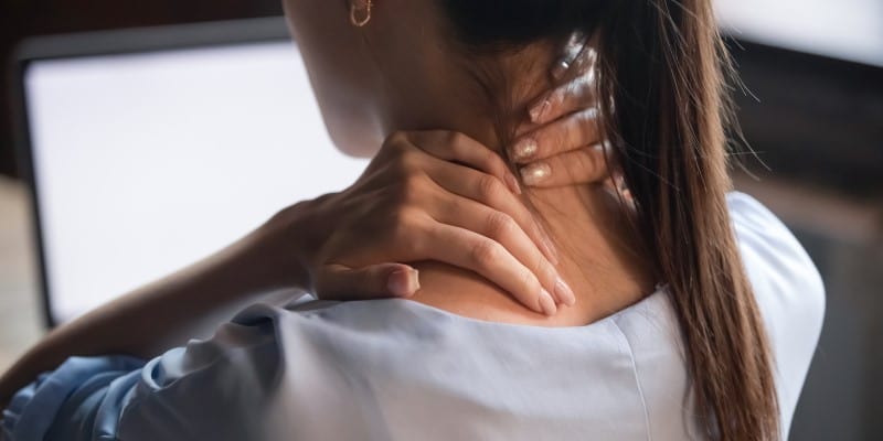 woman massaging stiff neck