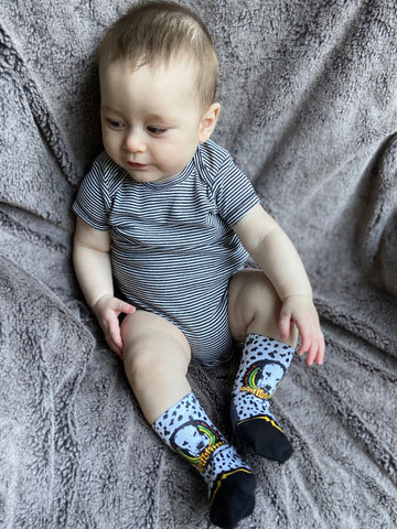 Baby wearing black and white Sublime dalmation baby socks.