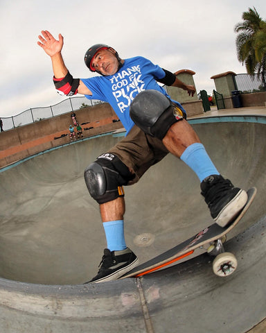 Steve Caballero skateboarding in skate park dropping into a bowl while wearing MERGE4 Repreve athletic socks.