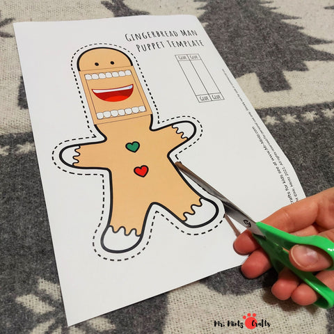 Two gingerbread man puppet crafts with movable mouths, one colored and one for coloring, showcasing bow ties and buttons, ready for creative play.