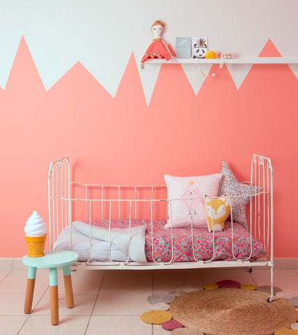 partial painting a wall with white and pink spikes or zig-zag