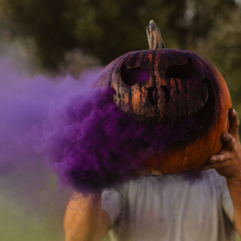 purple smoke bomb in a pumpkin