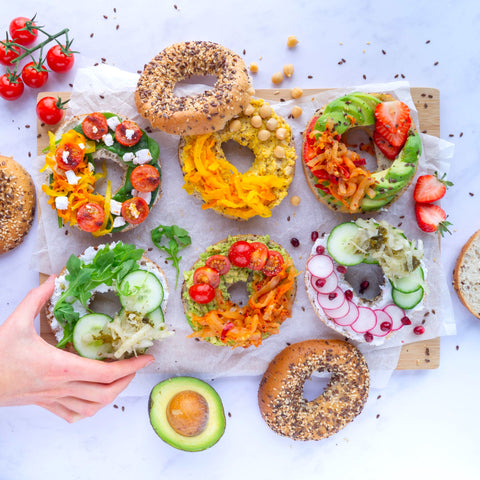 6 bagels, each topped with unique toppings, alongside Superkraut