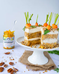 Carrot Cake, with a slice removed, with Turmeric & Ginger Superkraut in the background
