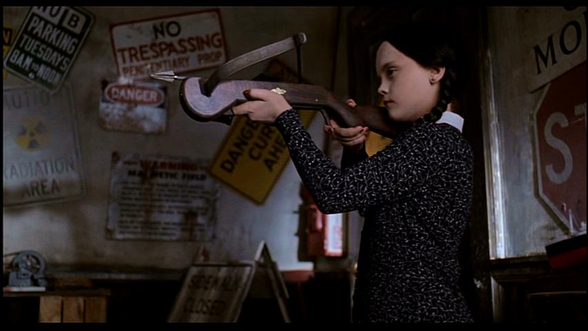 wednesday addams holding a crossbow