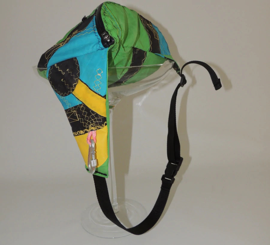 A brightly coloured fanny pack resting on a plinth