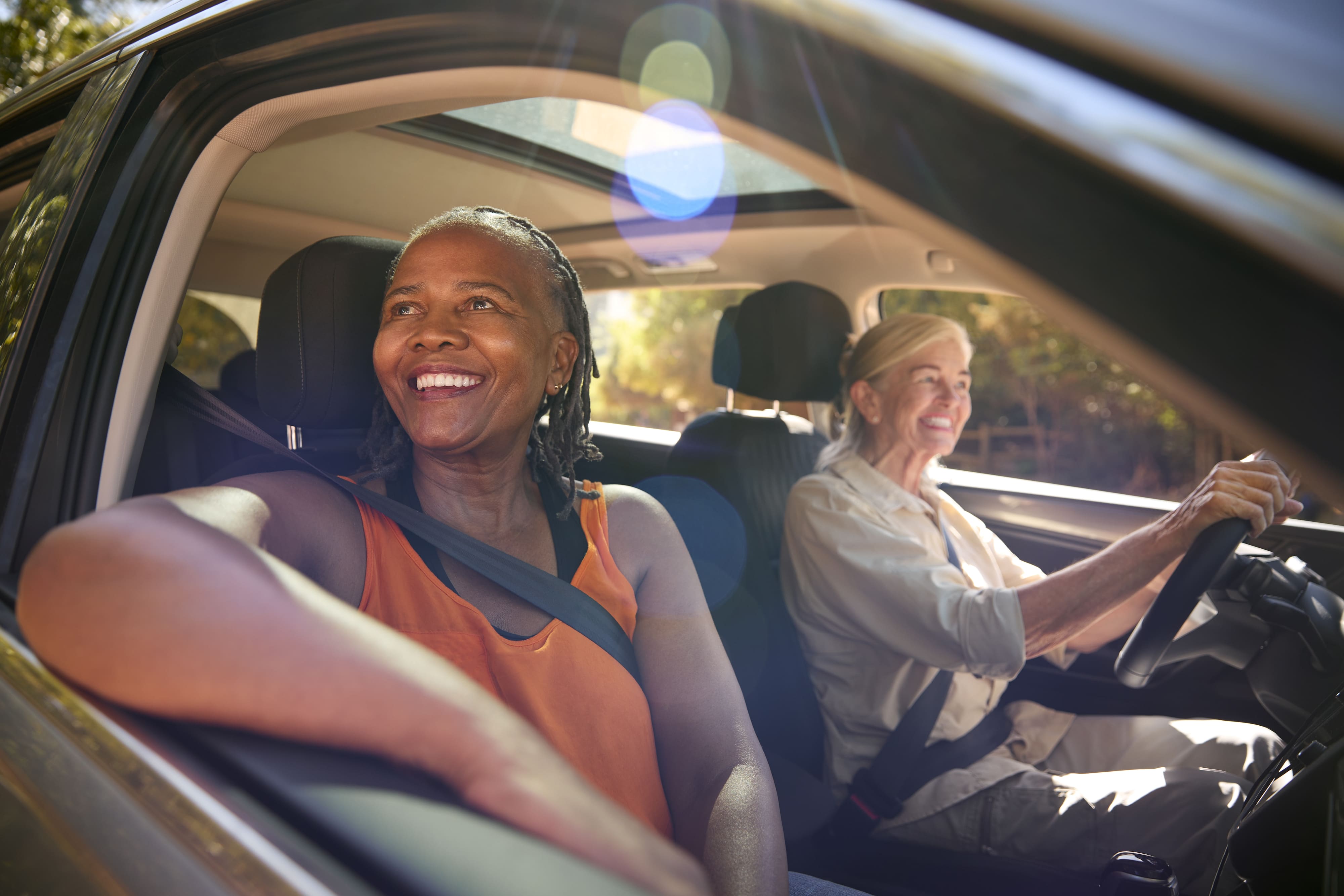 The Ultimate Guide to Renting a Car with Your International Driver's License, Two Senior Female Friends Enjoying Day Trip Out Driving In Car Together