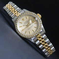 https://oldetownejewelers.com/collections/womens-wristwatches/products/stunning-1987-rolex-69173-datejust-18k-ss-diamond-bezel-tapestry-dial-watch