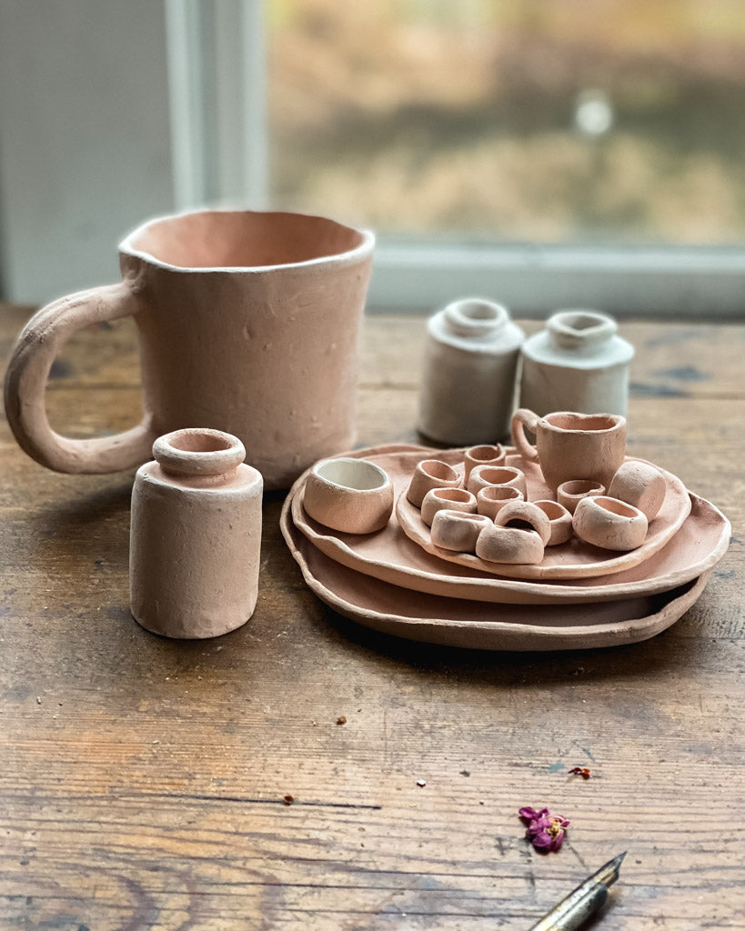 handmade clay mug, ink holder, paint pans, and plates