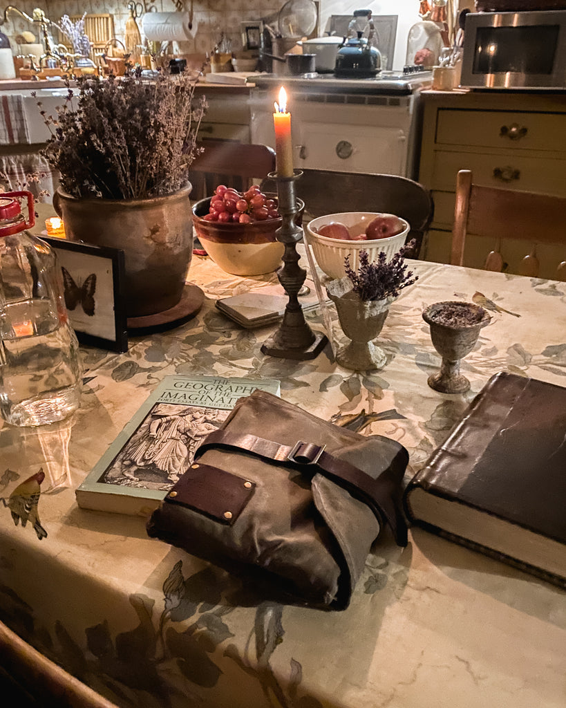 Candlelit kitchen table with Sendak Artist Roll and books