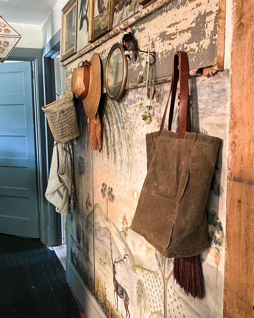 reusable waxed canvas everyday bag hanging in hallway