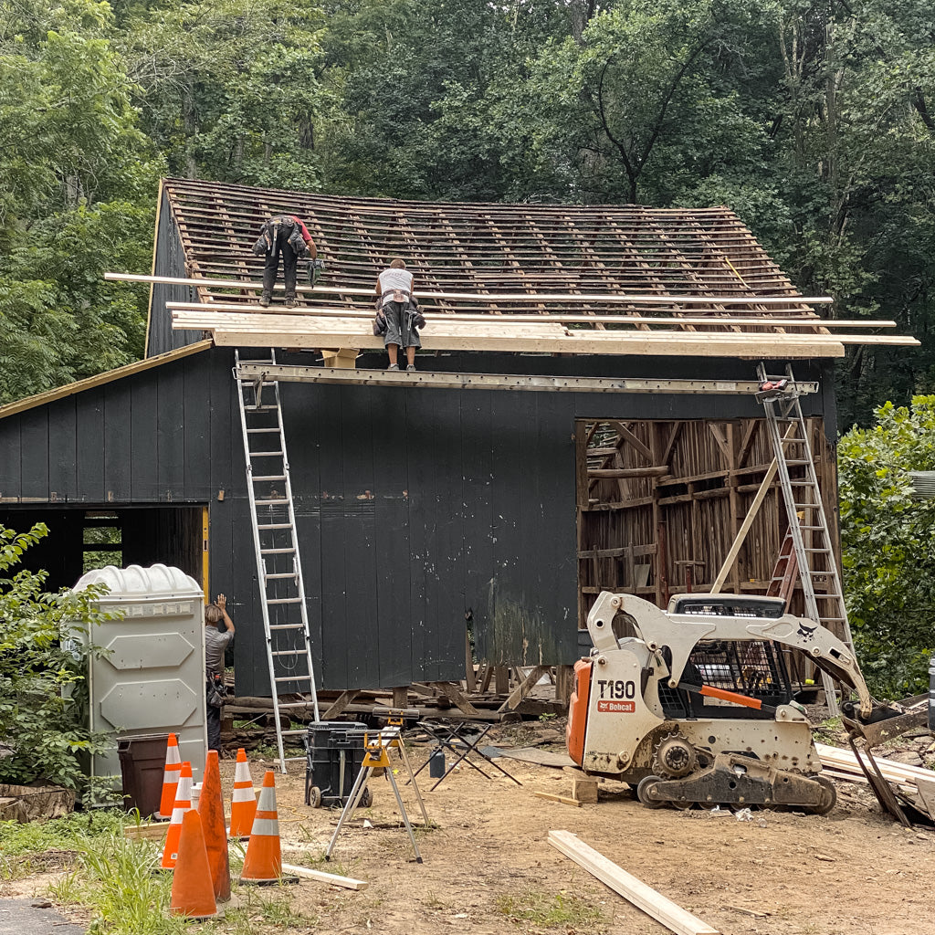 Removing Wooden Rafters During Barn Restoration