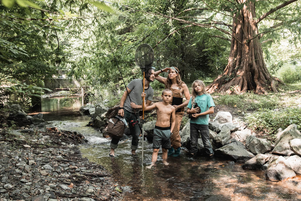 portrait of family standing in a creek