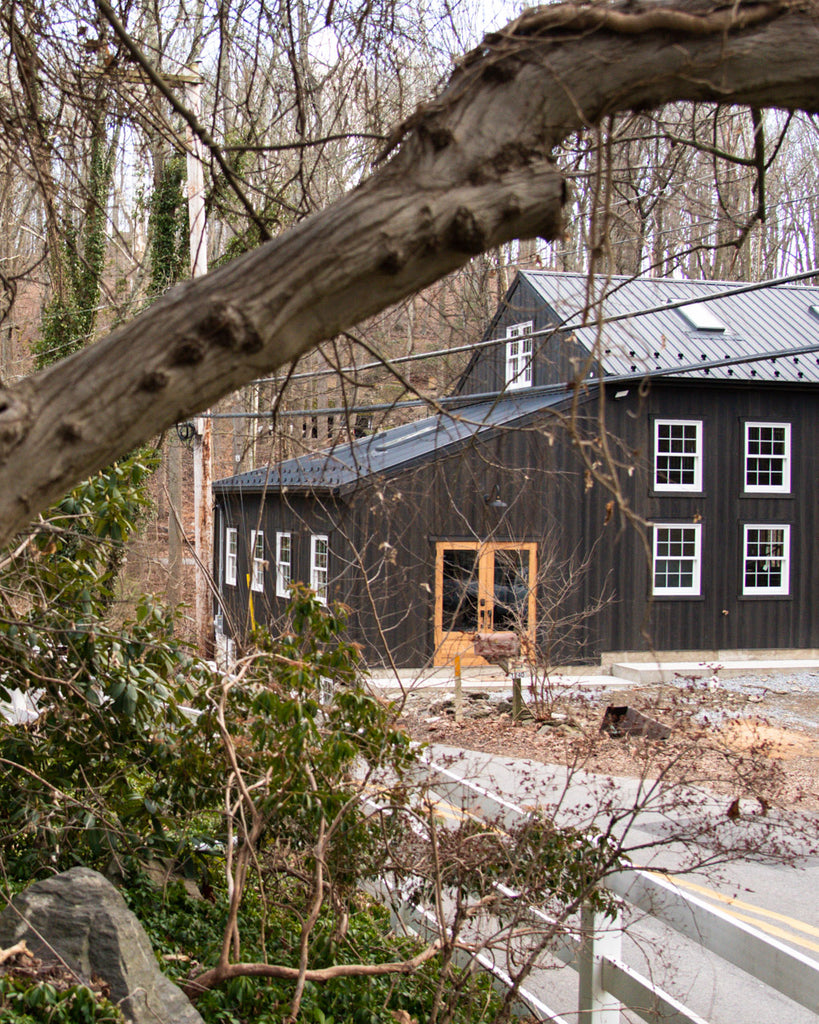 Restored Barn Exterior Through the Trees