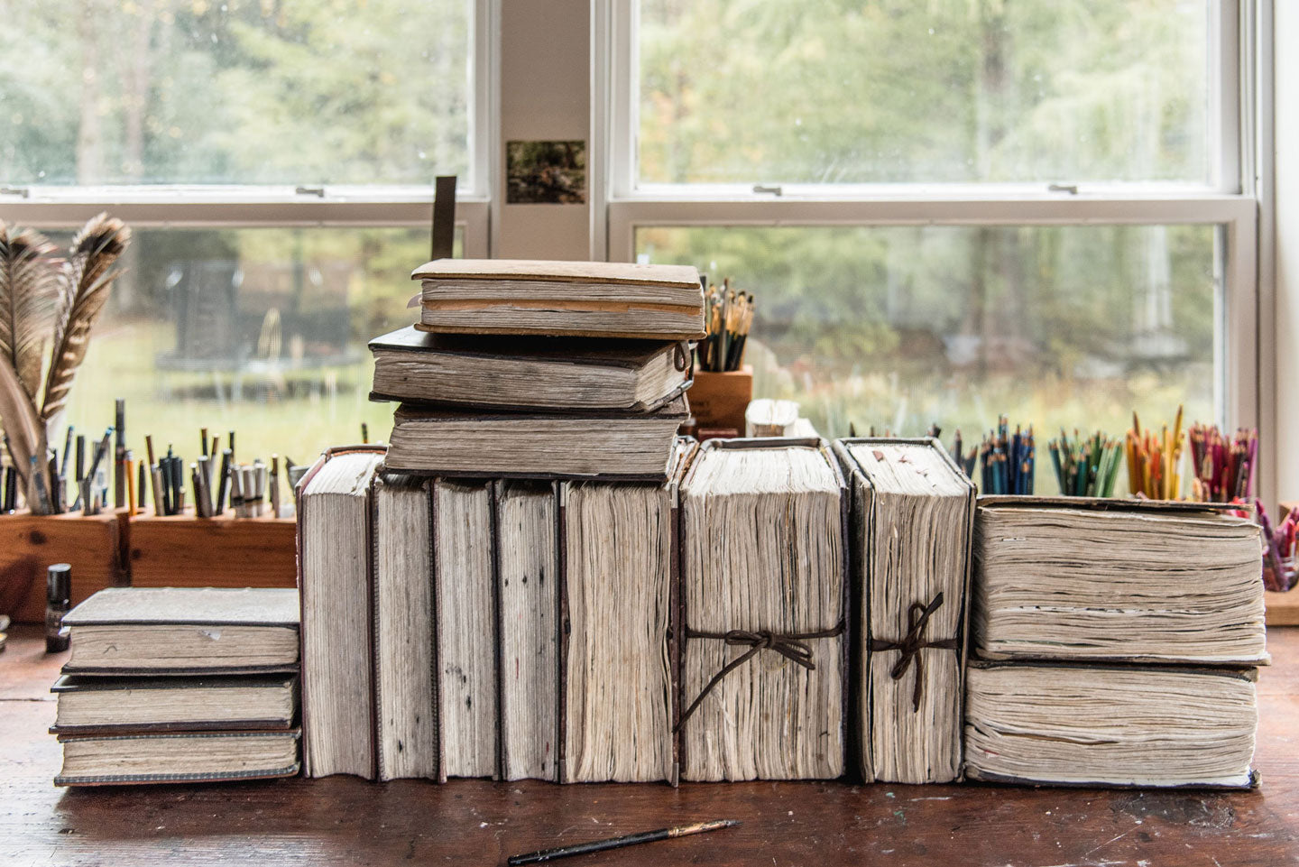 The well-worn pages of a collection handbound journals by Peg and Awl